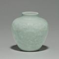A Rare Small Relief-Decorated Celadon-Glazed Jar. Qianlong seal mark in underglaze blue and of the period (1736-1795)