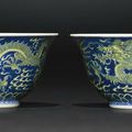 A fine pair of blue and yellow 'Dragon' bowls, Qianlong seal marks and period