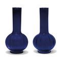 Two similar translucent blue glass lobed bottle vases, 19th century