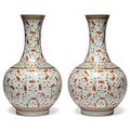 A pair of famille rose 'Hundred bats' bottle vases, Guangxu six-character marks in iron-red and of the period (1875-1908) 