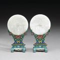 A pair of carved white jade circular plaques and cloisonné enameled metal stands. Qianlong Marks