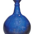 An intact Kashan blue-glazed bottle vase, Persia, 12th-13th century