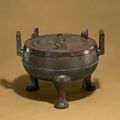 An archaic bronze ritual food vessel and cover, ding, Warring States period (B.C. 475-221)          