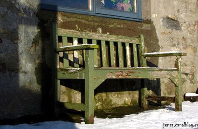 Seeing a wooden bench just at a bend in the road ahead, a place where you can expect to sit for a moment, catching your breath. 