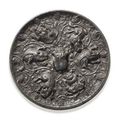 An unusual bronze circular 'lion and grapevine',  mirror. Tang dynasty (618-907).