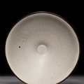 A small dingyao carved bowl, Northern Song dynasty & a small moulded longquan celadon 'lotus' dish Southern Song dynasty  