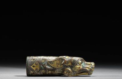 An archaic gold and silver-inlaid bronze ‘mythical animal’ ferrule, Eastern Zhou dynasty