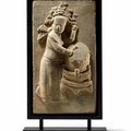 A Relief-Molded Gray Pottery Tile of a drummer, Song-Jin Dynasty (960-1134)