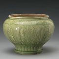 A Zhejiang celadon glazed jar with carved decoration. Ming Dynasty