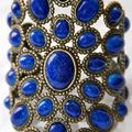 Andrew Gn, jewelled statement cuff cast in bronze with lapis blue glass cabochons in beaded oval settings
