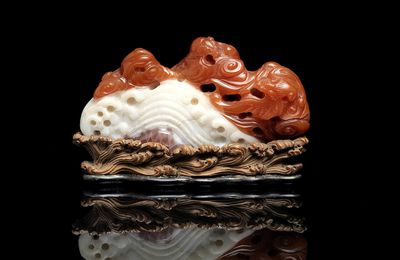 A rare carnelian agate 'mountain and bat' brushrest, Qianlong period (1736-1795)