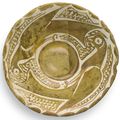 A small Abbasid lustre pottery bowl depicting two birds, Iraq, 9th century
