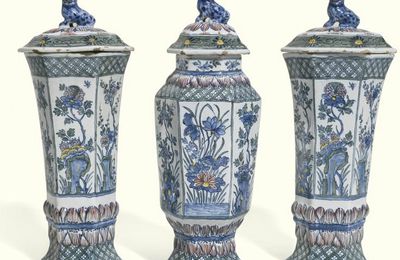 A garniture of three Dutch Delft polychrome vases and covers, early 18th century