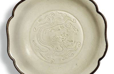 A carved 'Ding' 'dragon' dish, Northern Song dynasty (960-1127)