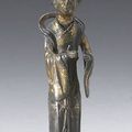 A gilt bronze figure of a female attendant. Ming Dynasty