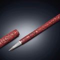 A carved red lacquer brush and cover, Ming dynasty, 16th-17th century