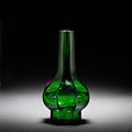 An octagonal facetted green glass bottle vase. Qianlong mark and of the period & An Imperial yellow glass bottle vase. Qing 