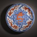 A magnificent large blue and white and iron-red 'dragon' dish, Qianlong seal mark in underglaze blue and of the period (1736-1795)