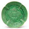 A molded green-glazed pottery dish, Liao dynasty (907-1125)