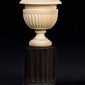 A German 19th century ivory vase on ebony pedestal