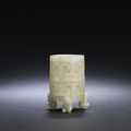 A rare archaistic pale green jade reticulated tripod cup, zhi, 17th-18th century