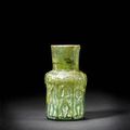 An Abbasid moulded glass Bottle with Figures. Persia or Mesopotamia, 8th-11th Century