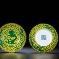 A fine pair of yellow-ground green-enamelled 'dragon' foliate dishes, Qianlong six-character seal marks and of the period 