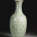 A rare moulded and carved celadon-glazed vase, Qianlong seal mark and period (1736-1795)