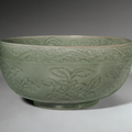 A rare carved Longquan celadon deep bowl, Ming dynasty, early 15th century