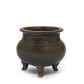 A black and russet-glazed globular tripod incense burner, Tang Dynasty (618-907)