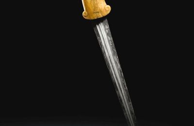 A Mughal carved marine ivory-hilted dagger with ram's head, 17th century