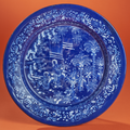 Nevers. Plat rond à fond bleu persan, décoré en blanc fixe d’une scène animée de personnages chinois. Seconde moitié du XVIIème 