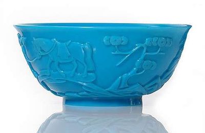 A blue-turquoise-colored Beijing  glass bowl with carved buddhist scene, China, 19th century