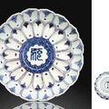 A rare blue and white and iron-red moulded 'lotus' dish. Wanli underglaze-blue six-character mark within double circles 
