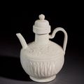 A superb and very rare carved white ware ewer and cover, Liao dynasty (AD 916-1125)