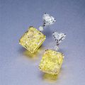 A pair of 18.12 and 18.22 carat fancy yellow diamond ear pendants