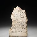 An Egyptian limestone stelophorous statue fragment. New Kingdom, 18th Dynasty, circa 1550-1295 B.C.