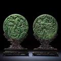 A fine pair of Imperial spinach-green jade double-carved circular table screens, Qianlong-Jiaqing period