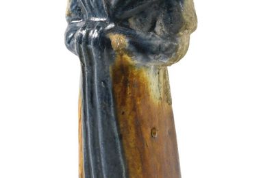 A rare blue and russet-glazed pottery figure of a lady, Tang dynasty (618-907)