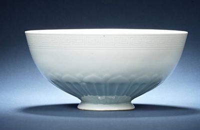 A moulded white-glazed bowl, lianziwan. Qianlong seal mark and of the period