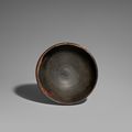 A burnished black pottery alms bowl, patra, Tang dynasty (618-907)