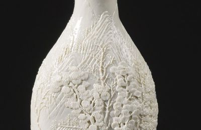 A carved and molded porcelain 'Landscape' snuff bottle, signed Chen Guozhi, Qing dynasty, 19th century