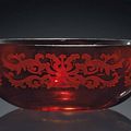 A carved red-glass 'Lotus' bowl, Qianlong four-character mark within a square and of the period (1736-1795)