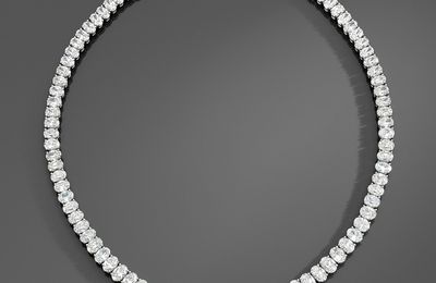A platinum and 18K gold necklace set with 93 oval-shaped diamonds