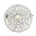 Belle epoque diamond and pearl circle and star brooch by Cartier, Paris c.1910