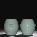 A pair of celadon-glazed drum-shaped jars , Qianlong six-character seal marks and of the period (1736-1795) 