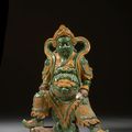 A green and yellow glazed pottery figure of guardian, China, Ming dynasty, 17th century 