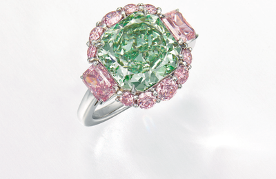 A charming fancy intense green diamond and diamond ring