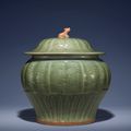 A carved Longquan celadon jar and cover, Ming dynasty, 15th century