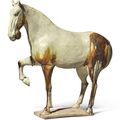 A large glazed pottery figure of a prancing horse, Tang dynasty (618-907)